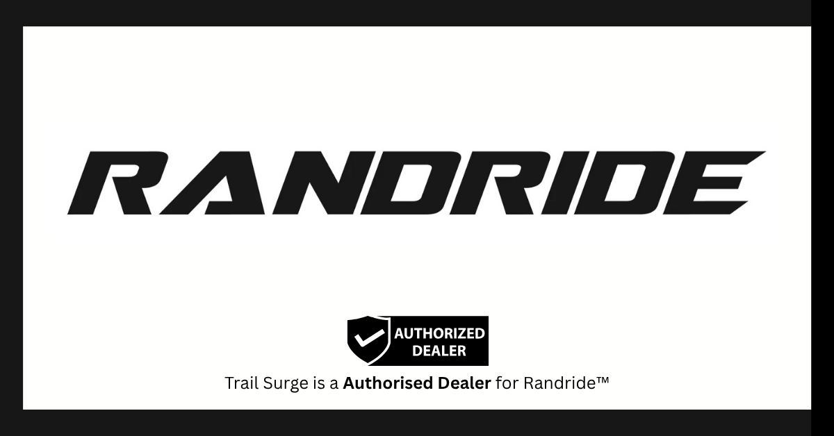 The image displays the Randride logo in bold, black letters. Below it, there is a shield icon with a check mark, the text Authorized Dealer, and a note stating Trail Surge is an authorized dealer for Randride.