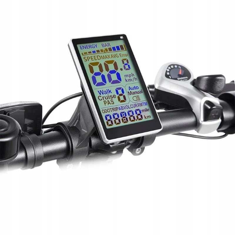 A close-up of a bicycle handlebar displaying a digital screen with speed, battery, and various mode indicators in color. The throttle and brake controls are also visible.