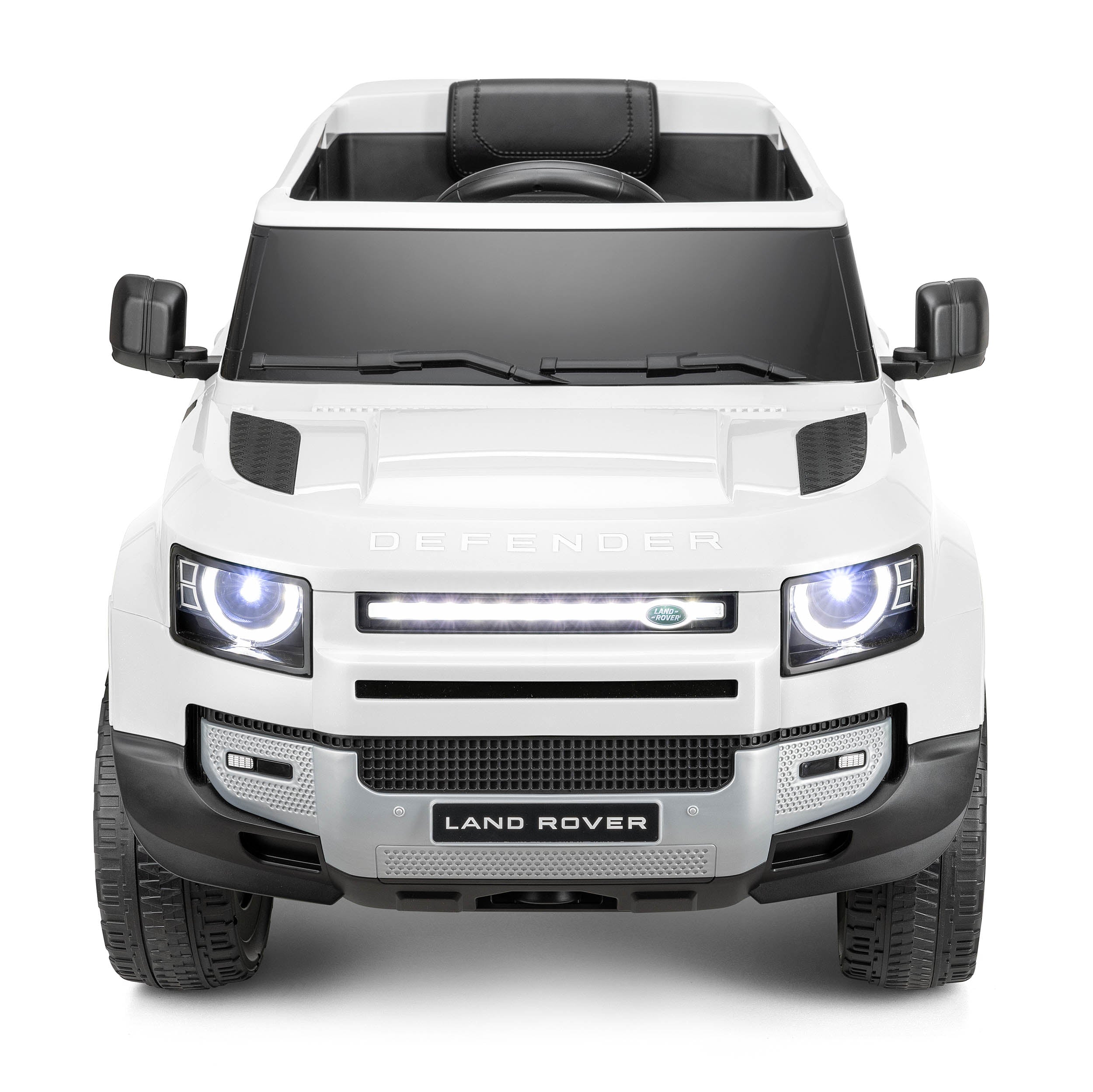 Front view of white Land Rover Defender kids electric ride-on car with headlights and detailed grill design