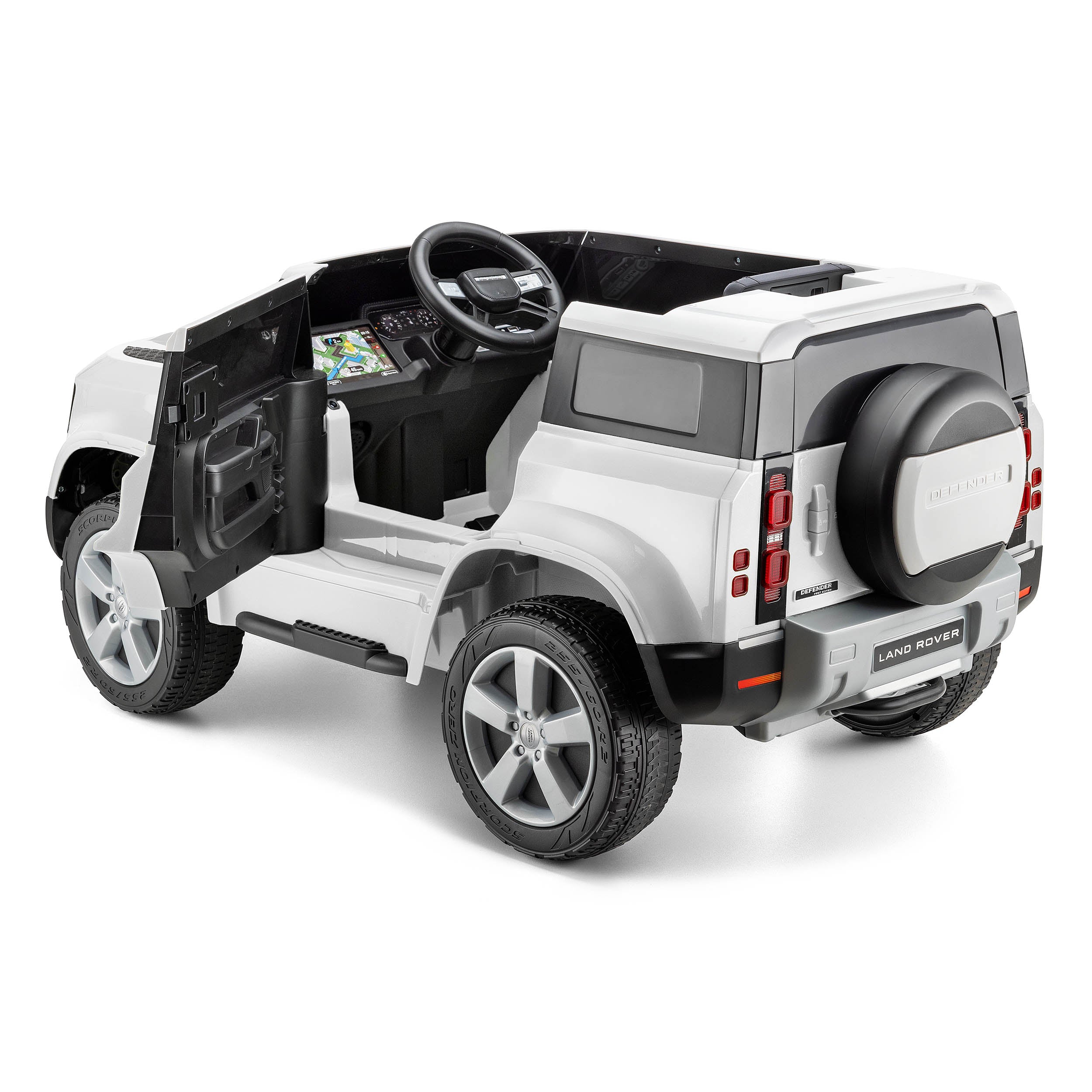 White Land Rover Defender kids electric ride-on car with opening doors and realistic dashboard details on white background
