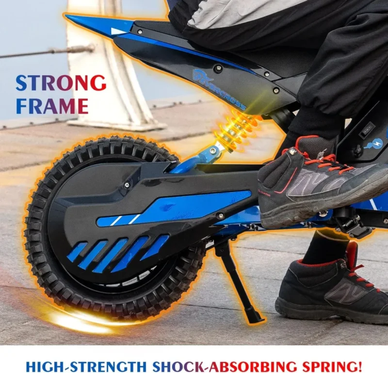 Close-up of a person’s foot on the pedal of a blue electric bike with thick tires, a visible yellow shock-absorbing spring, and the text “STRONG FRAME” and “HIGH-STRENGTH SHOCK-ABSORBING SPRING!”.