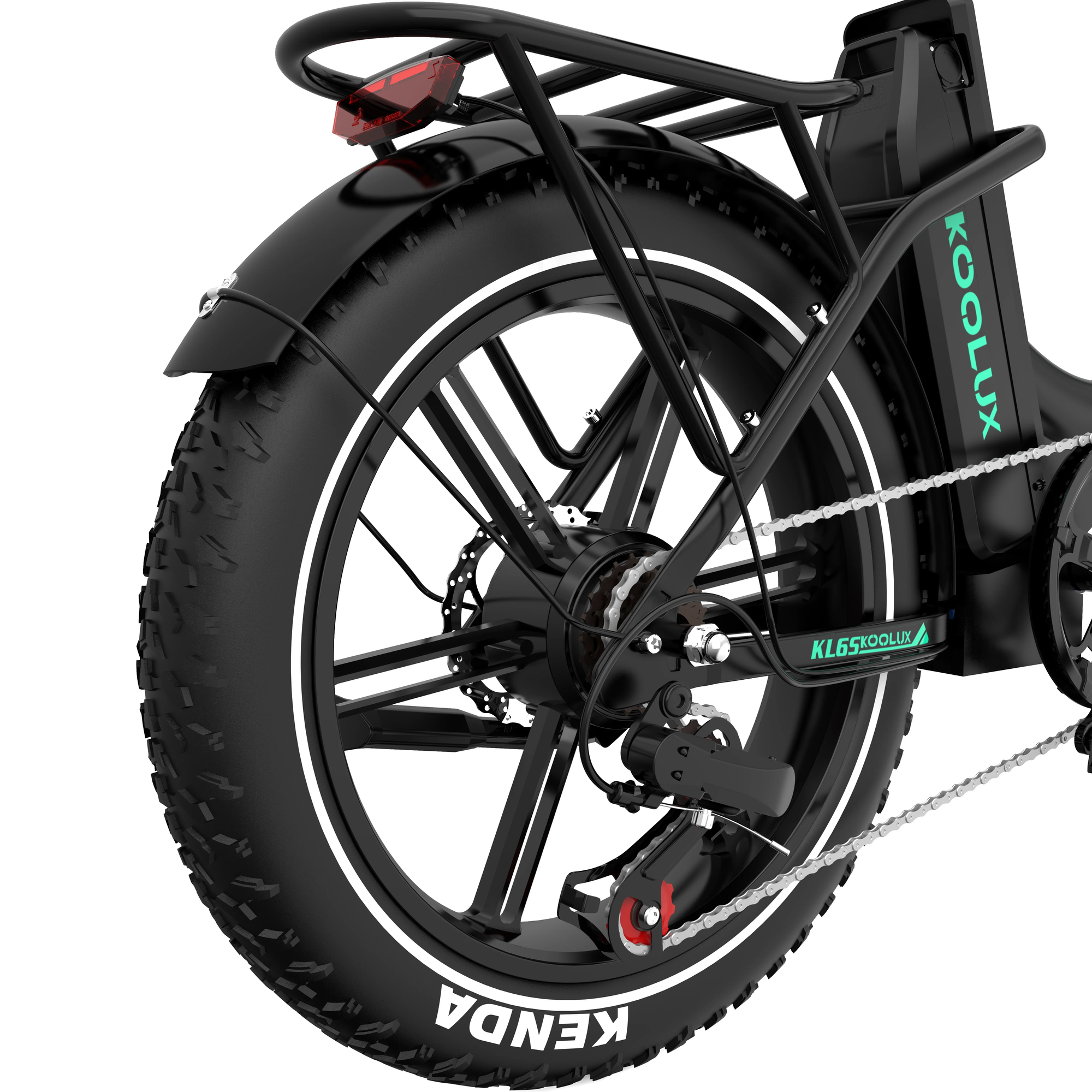 Close-up view of the rear wheel and gear mechanism of a black electric bicycle with thick Kenda tires, a rear rack, and the brand name Koolux on the frame.