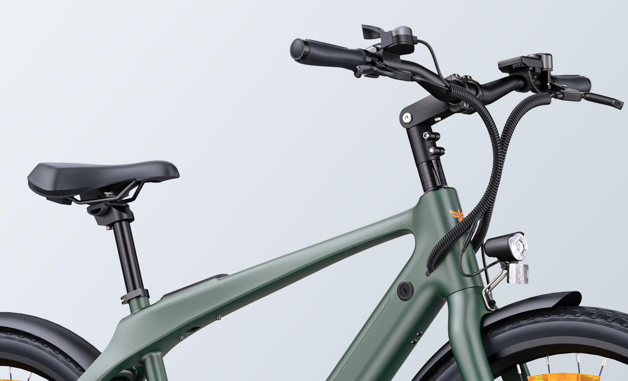 Close-up of a matte green electric bicycle showing the handlebars, front light, seat, and thick frame, with cables neatly organized along the front.
