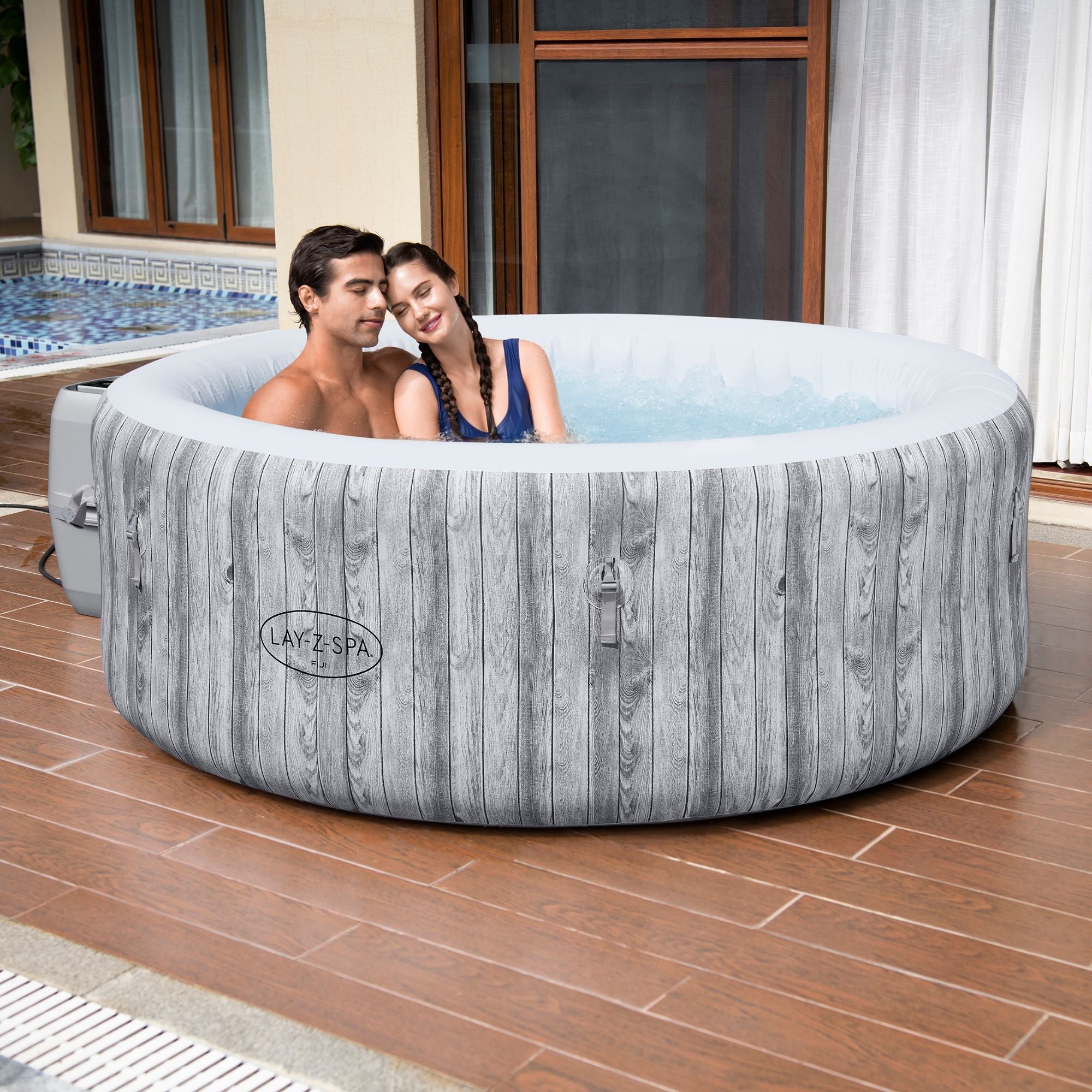 Round Lay-Z-Spa Fiji inflatable hot tub shown in a garden