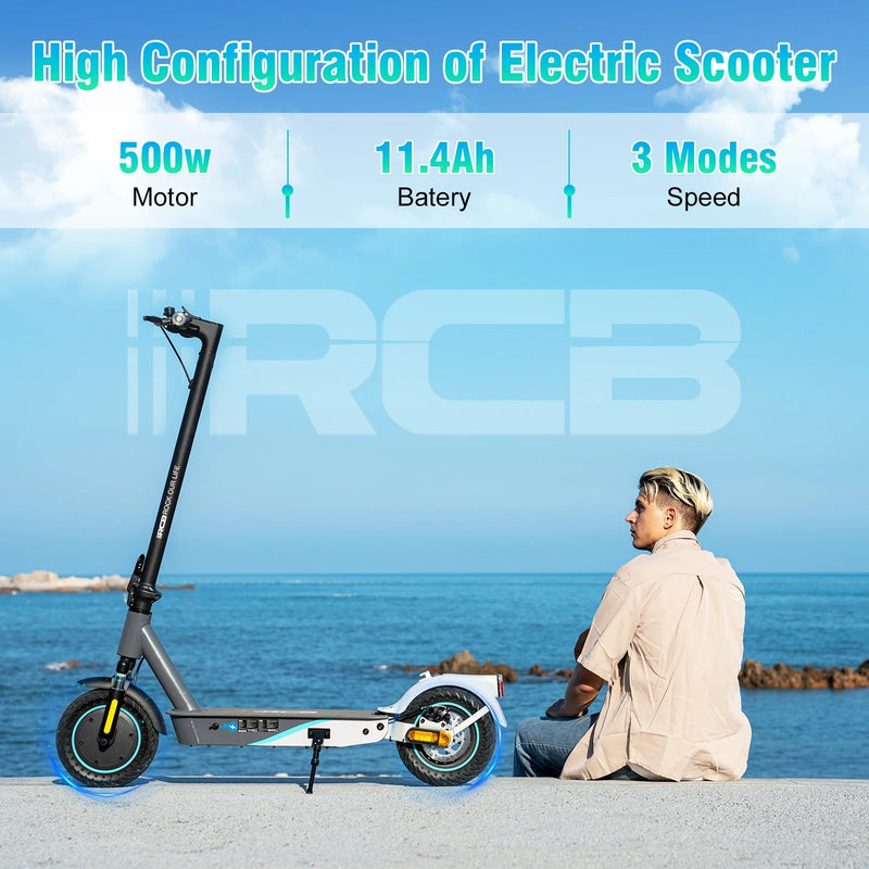 A man sits by the sea next to a black electric scooter. Text above highlights features: 500W motor, 11.4Ah battery, and 3 speed modes. The sky and water are blue, and the brand RCB is displayed in the background.